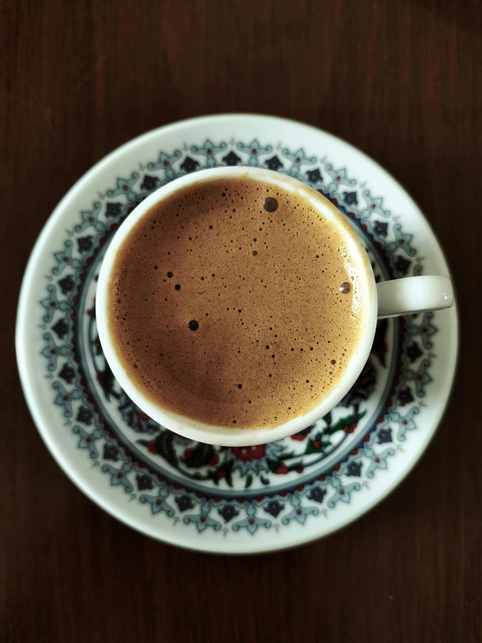 a closeup view of a beverage in a coffee cup on a saucer