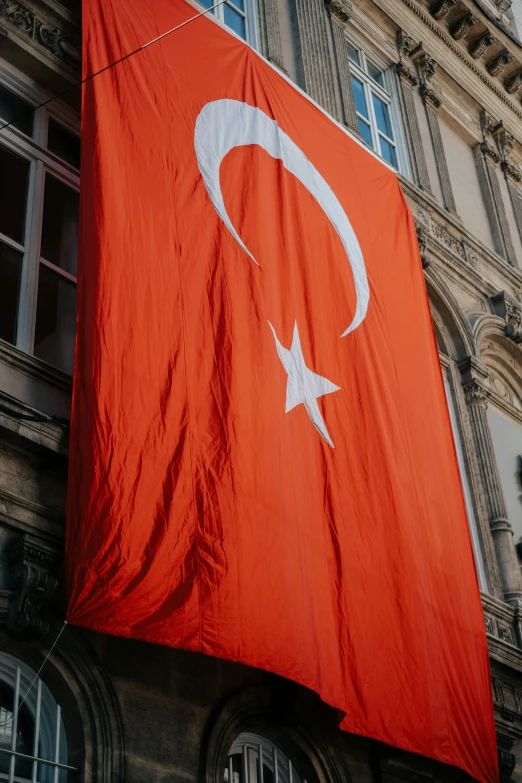 red banner with star and crescent on building