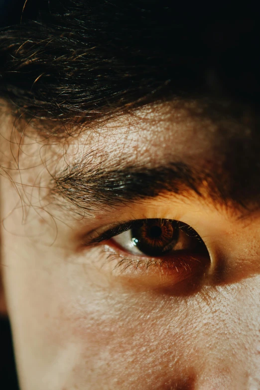 a man with curly hair on his face is looking directly into the camera