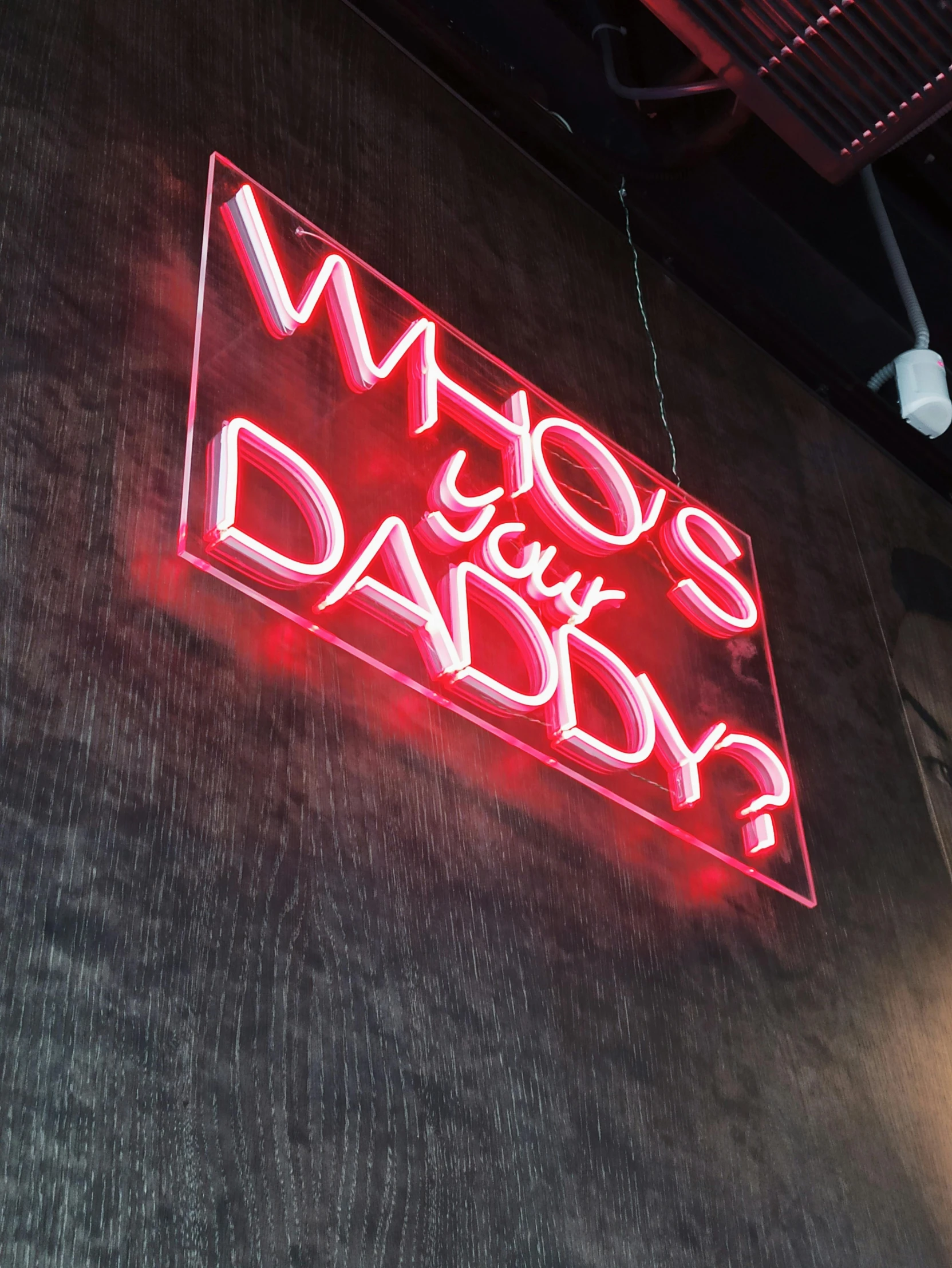 a neon sign that says who's your daddy?