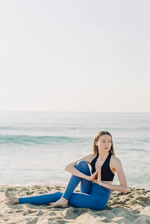 woman on beach stretching and yoga pose to improve balance