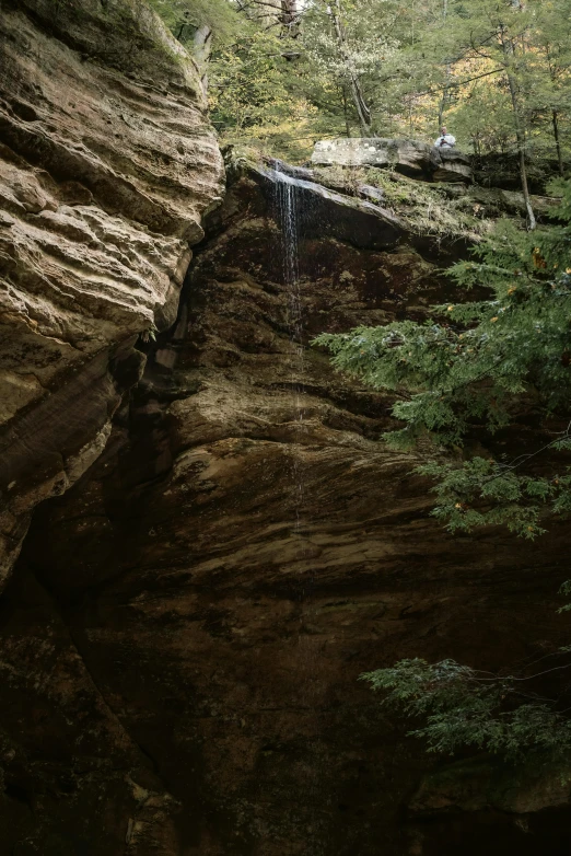 a waterfall flowing into a deep ravine between tall rocks