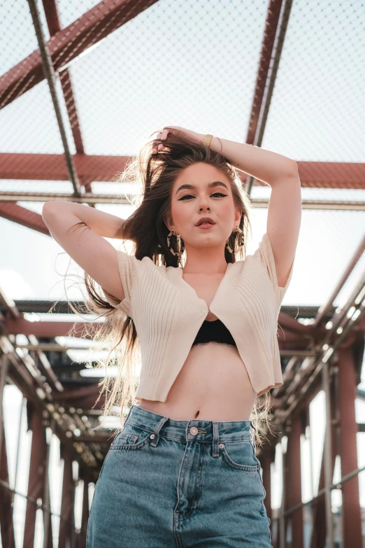 a girl with her hair in the air posing for a picture