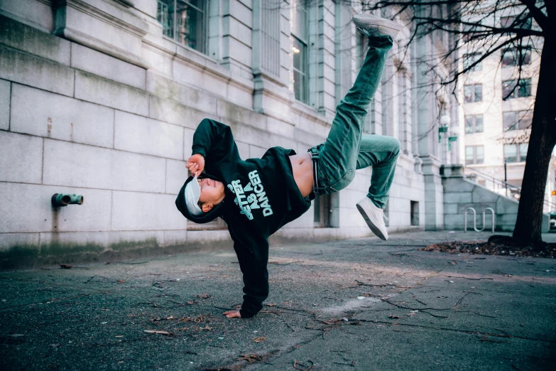 a man performing a kickbox move with one leg in the air