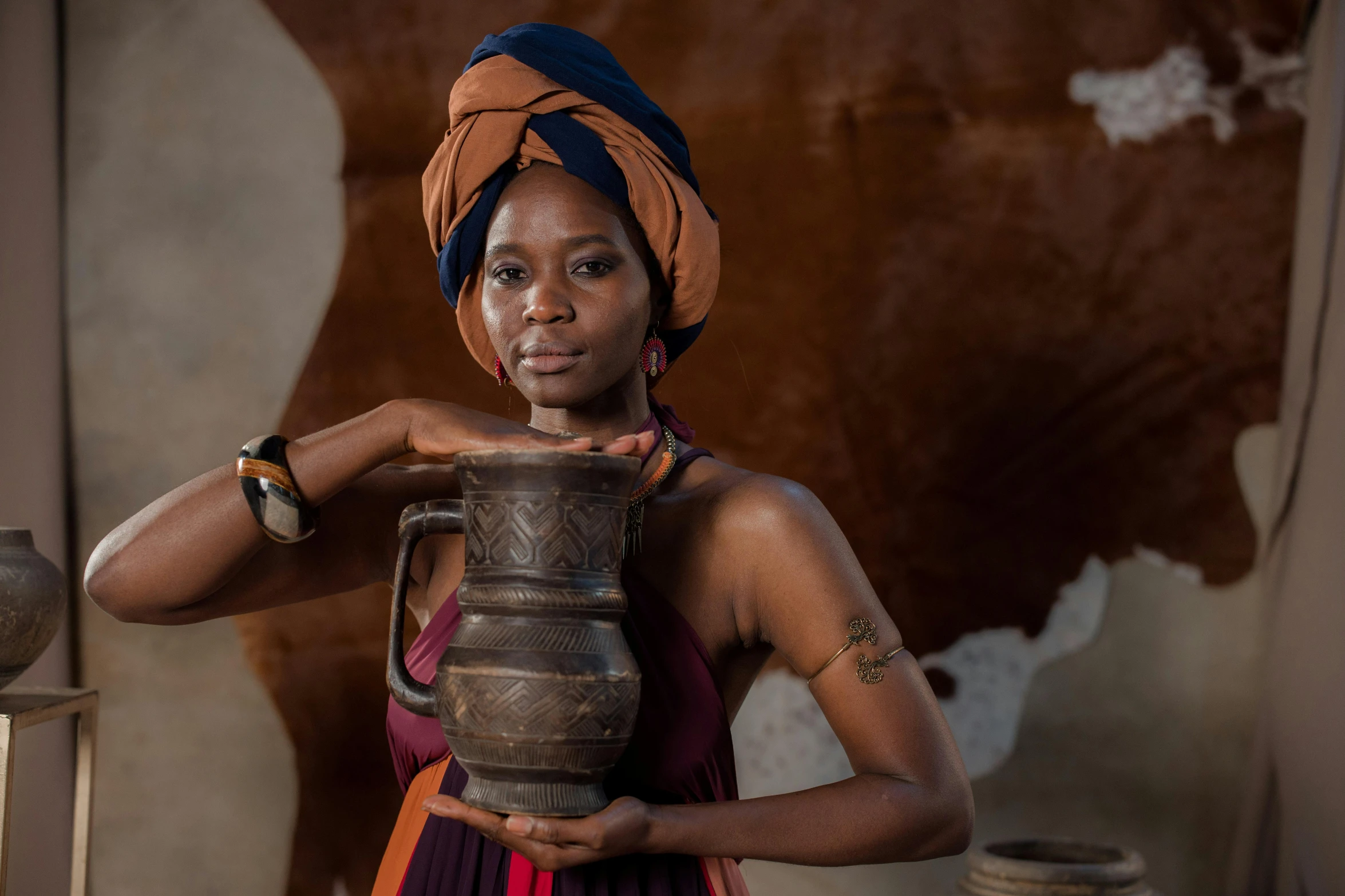 a woman holding a jug posing for a picture