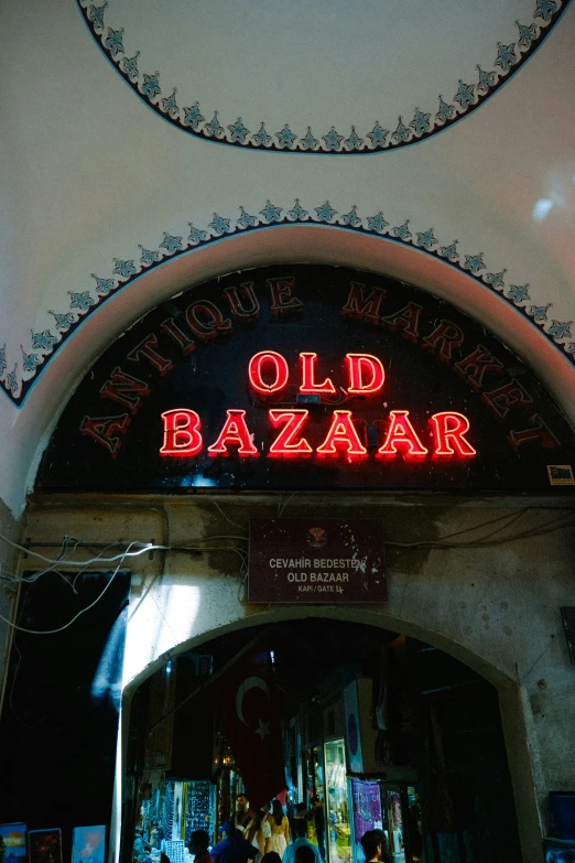 a large building with an old bazaar neon sign