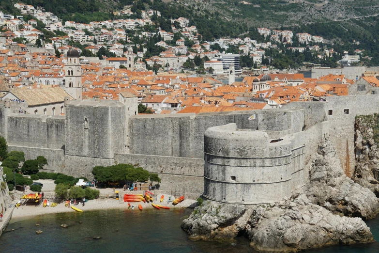 an old city with large red roofs is seen from above