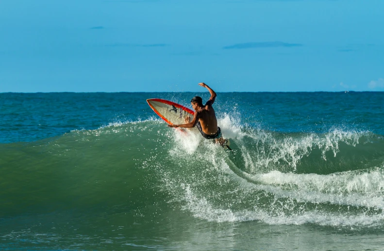 a man is surfing on a small wave