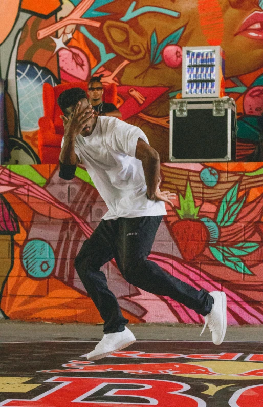 a man running in front of colorful wall with basketball hoop