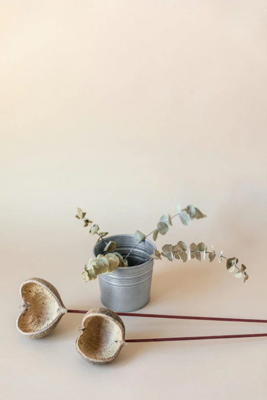 two vases on top of a table with a twig in them