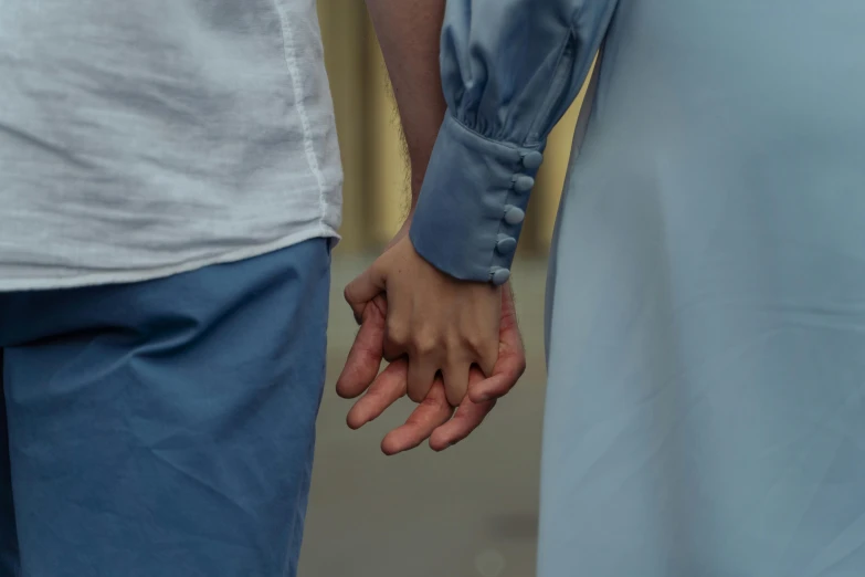 a closeup of two people with their hands in one hand