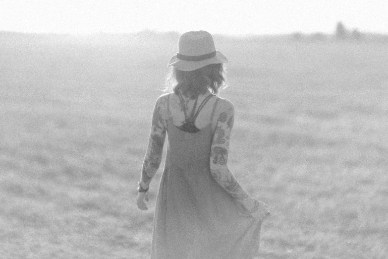 a woman walking across a lush green field