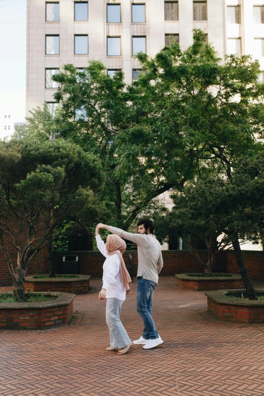 a woman standing next to a man in front of a tall building