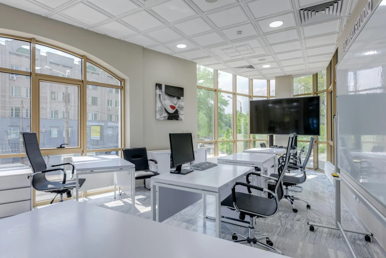 the interior of a room with lots of office chairs and desks