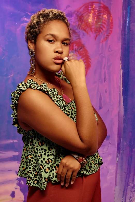 a woman posing in front of a purple background