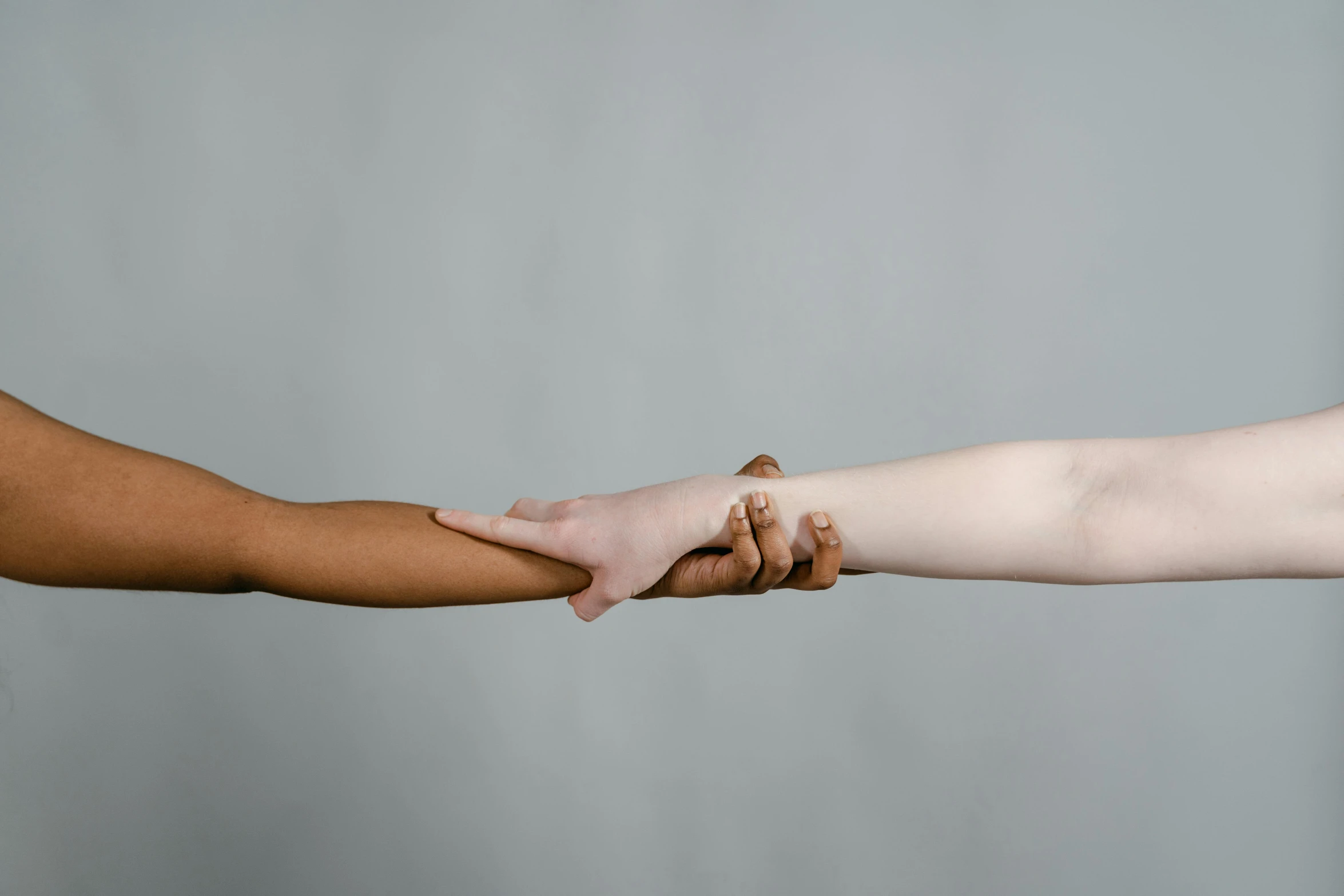 two people holding hands while they are close together