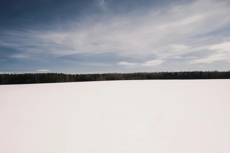 a man walking across a snow covered field