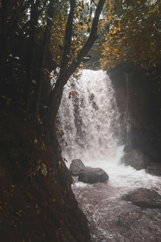 a big waterfall pouring down into some water