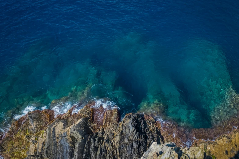 an aerial view of a beach with cliffs and water waves