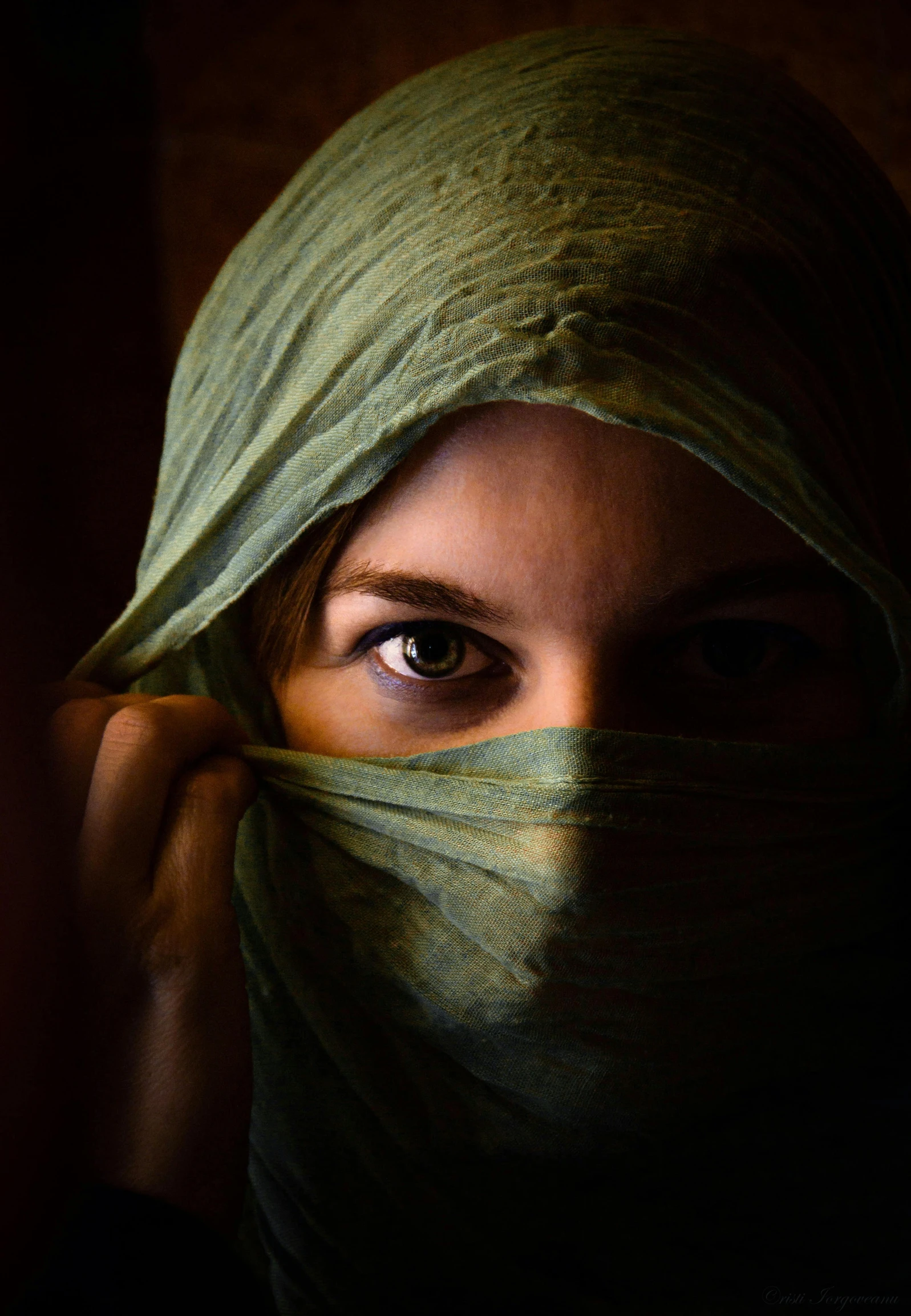 a woman with a veil covering her face