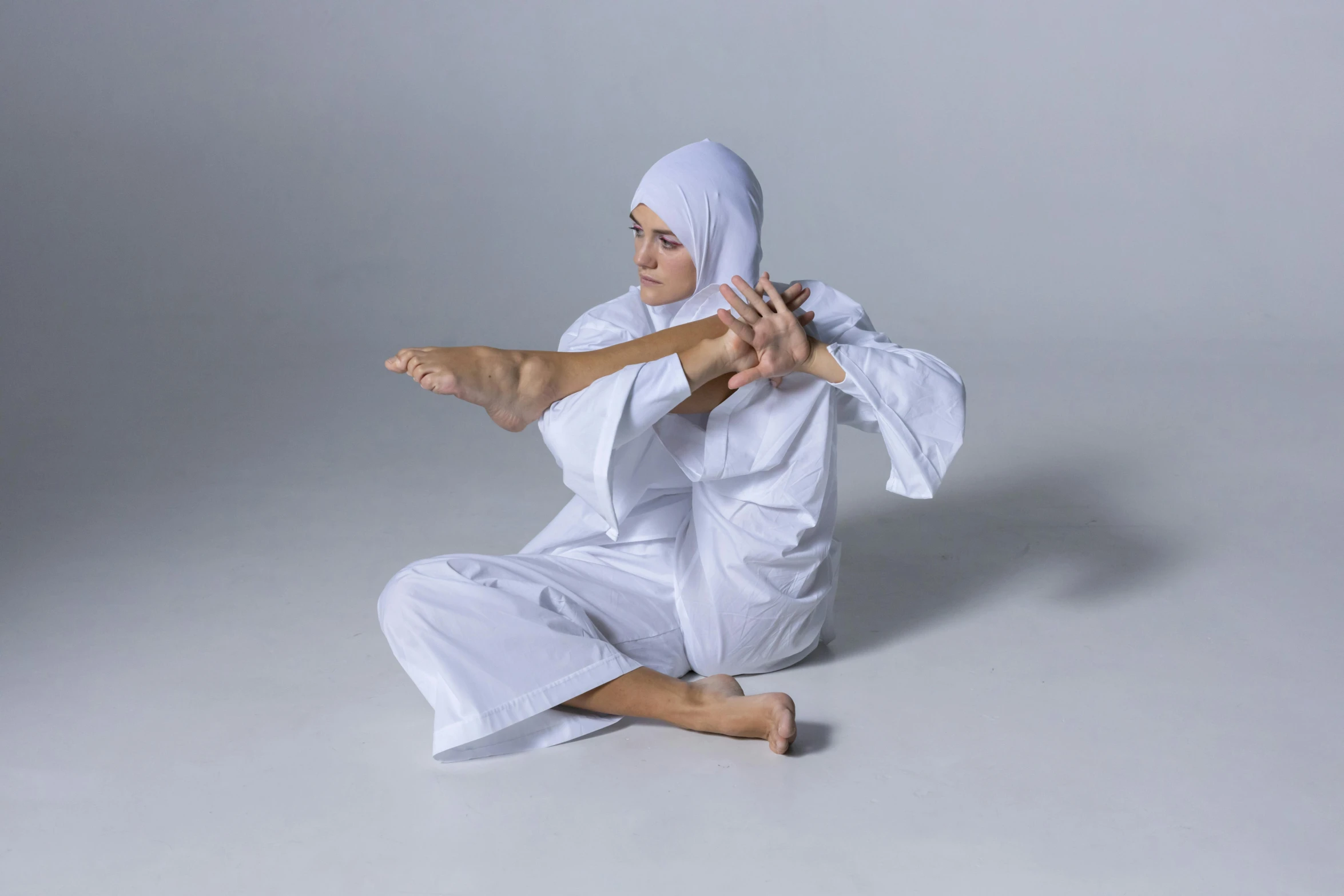 a man wearing a white robe doing a trick