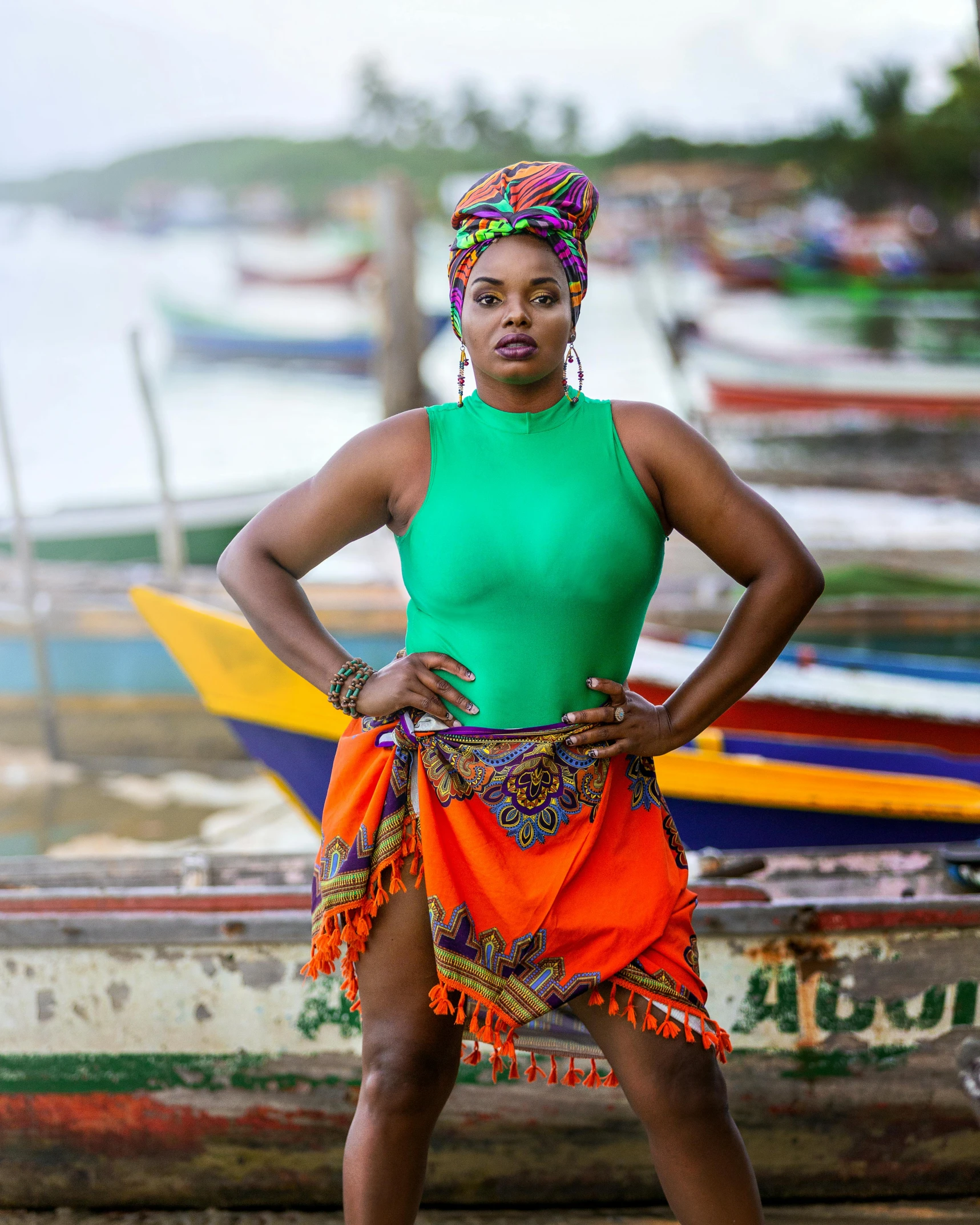 a woman is standing in front of a row of canoes