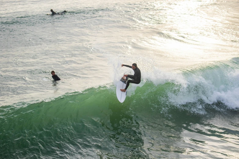 two people are surfing a wave in the ocean