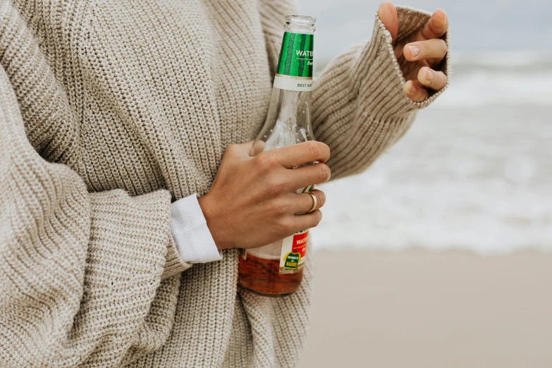 a close up of a person holding a bottle