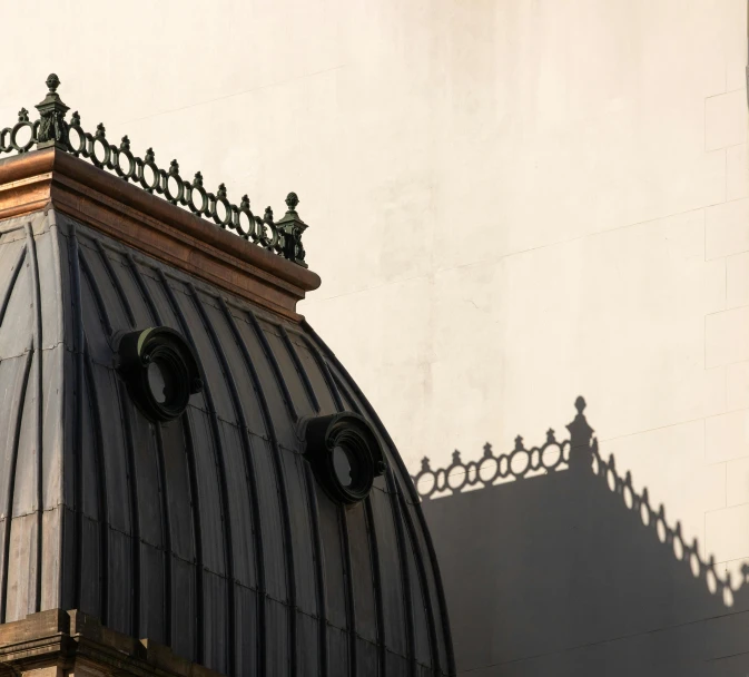 an old building with a roof with two round windows