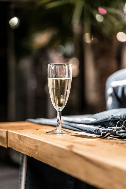 the glass is next to a cell phone on the table