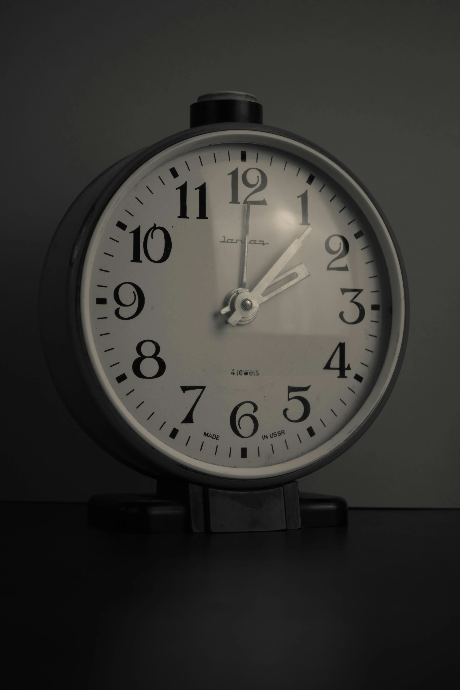 a white clock sitting on top of a table