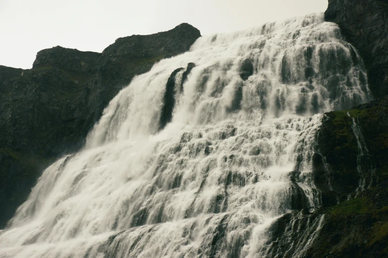 a waterfall is shown on a rocky surface