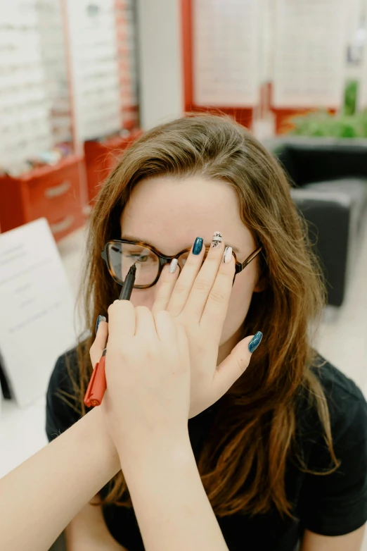 two women are covering their faces with scissors