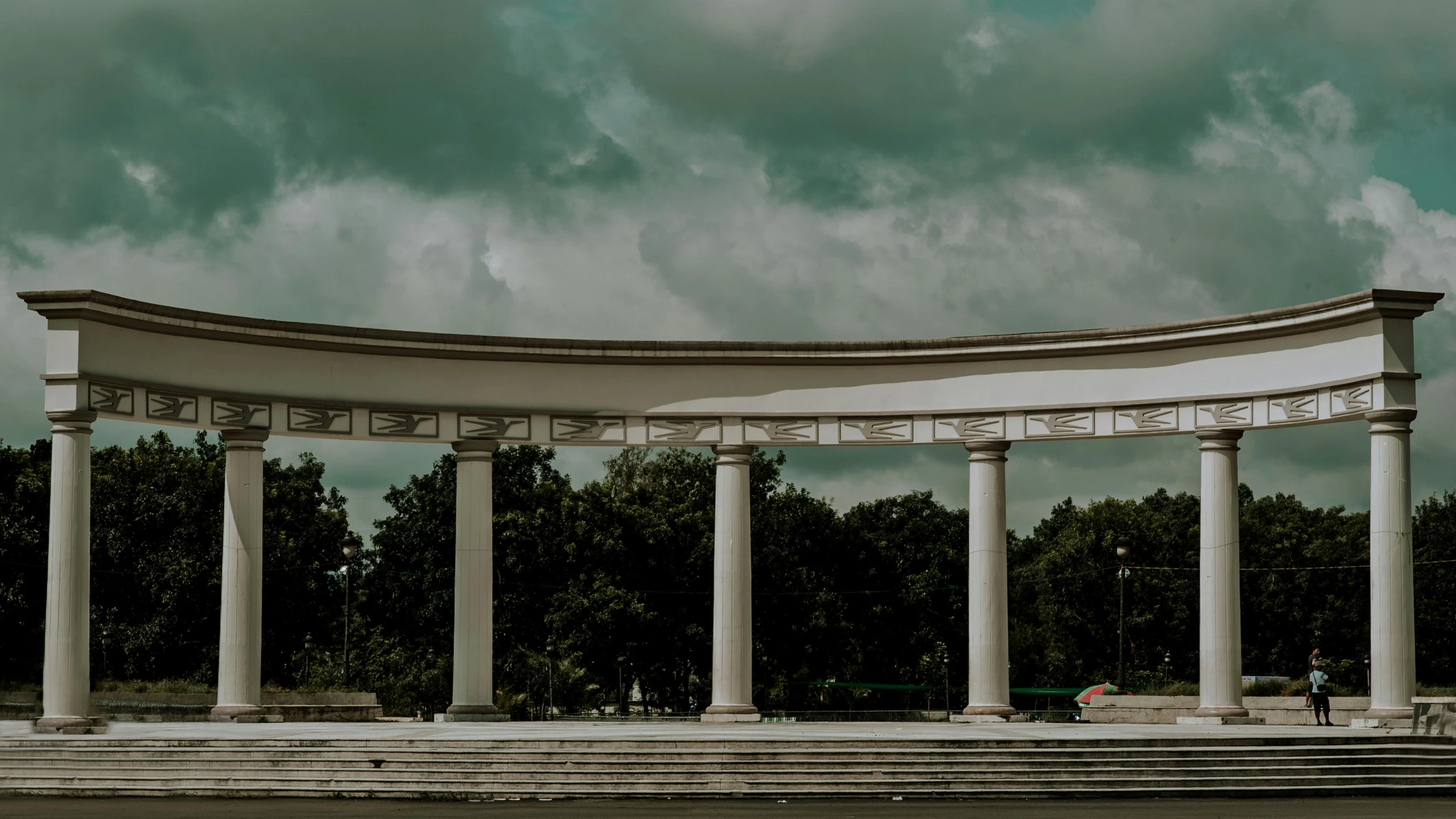 a white archway on top of steps and a building