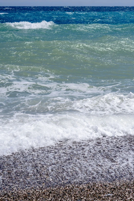 the surfer stands on his board in the ocean