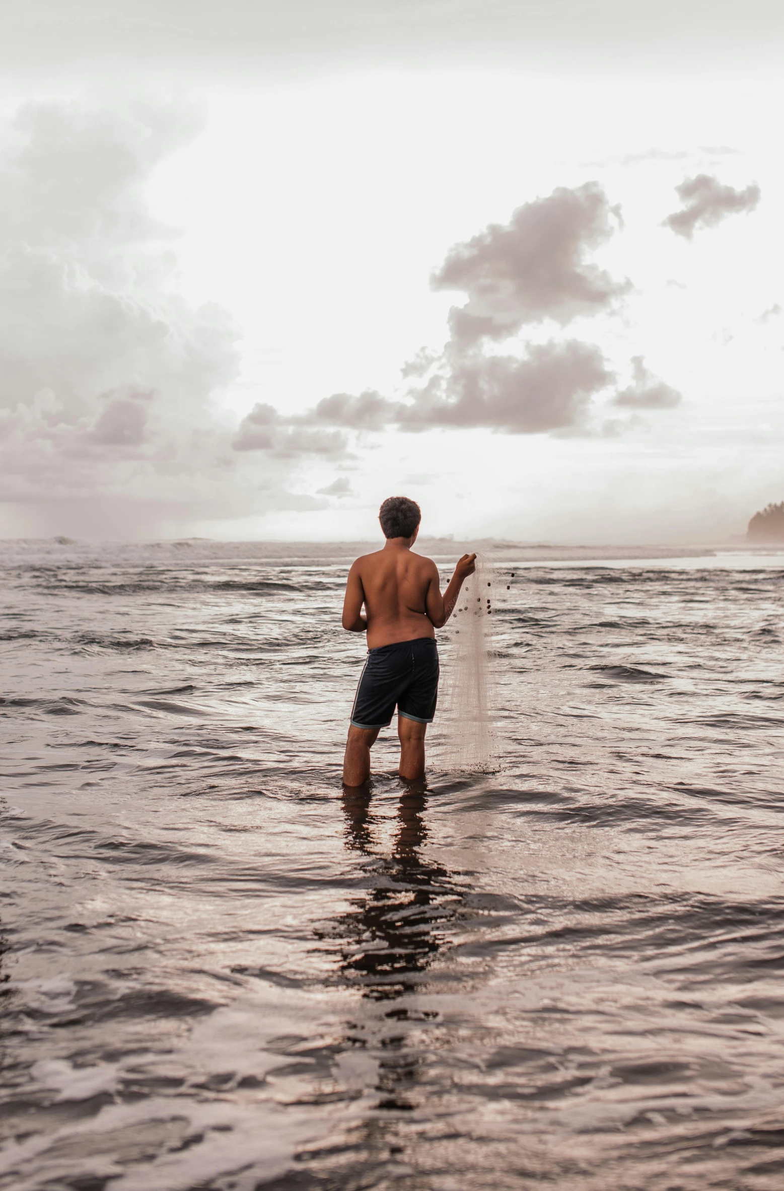 this man is trying to fish on the beach