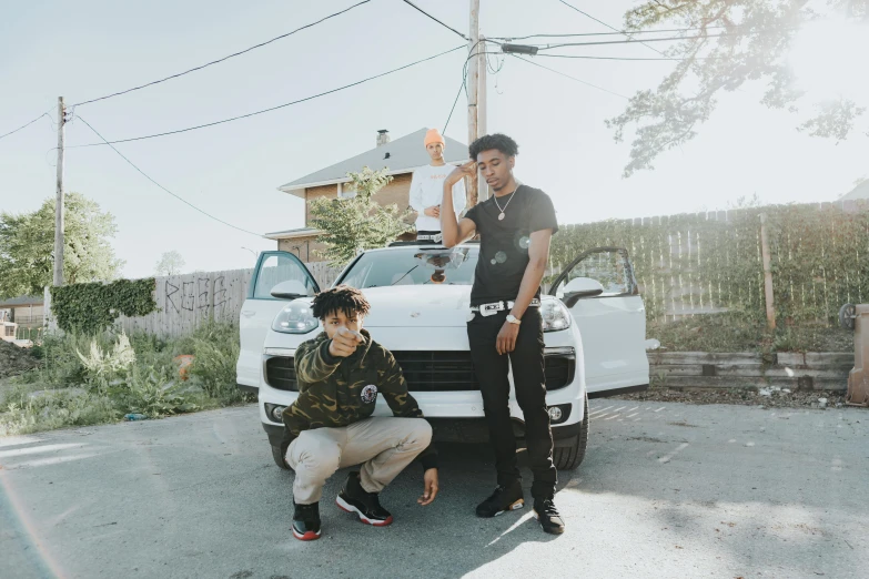 two people sitting by a white truck in front of a house