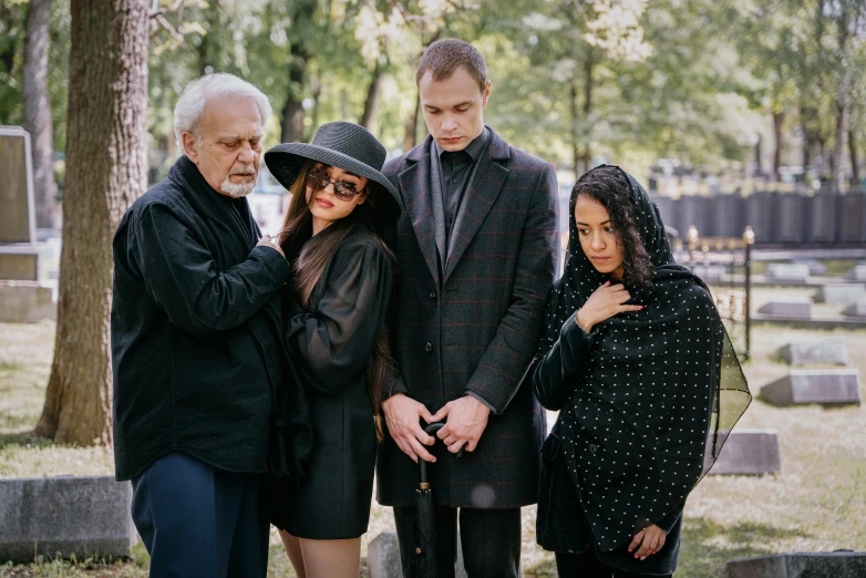 group of friends standing together in a graveyard