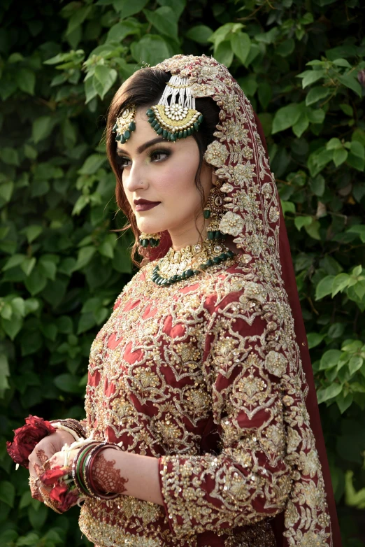 woman in red bridal outfit with floral jewellery