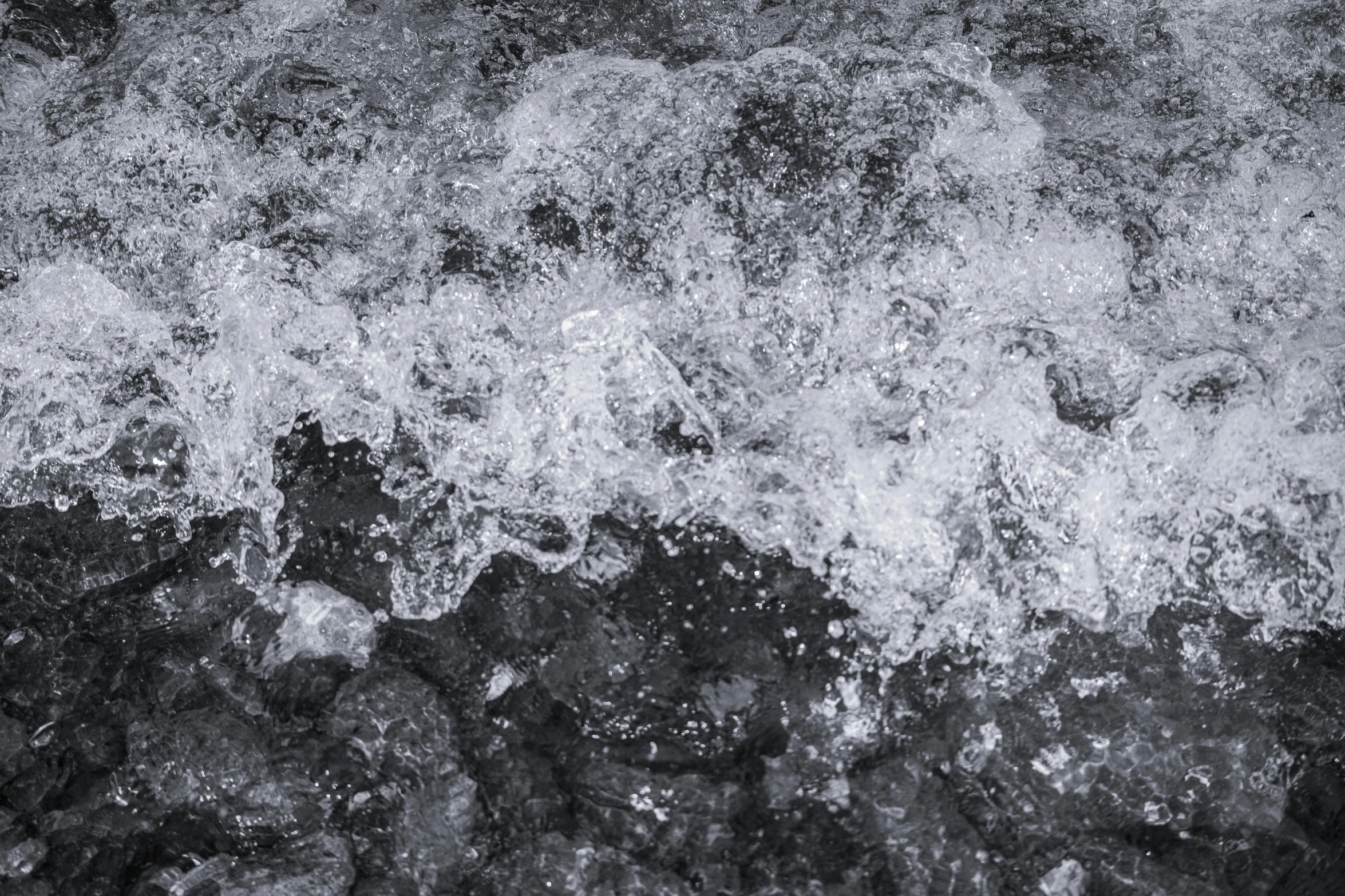 water and rocks in a river with foamy waves