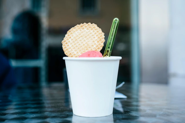 a plastic cup that has some different types of food in it