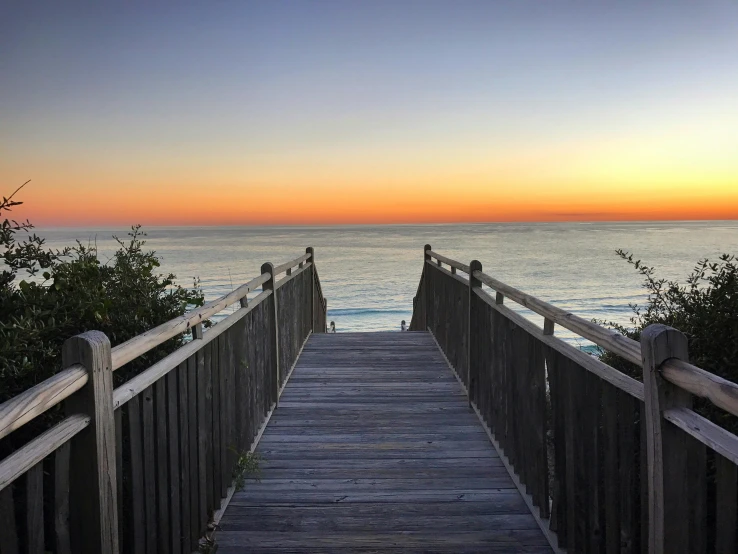 a wooden ramp with some water and an ocean