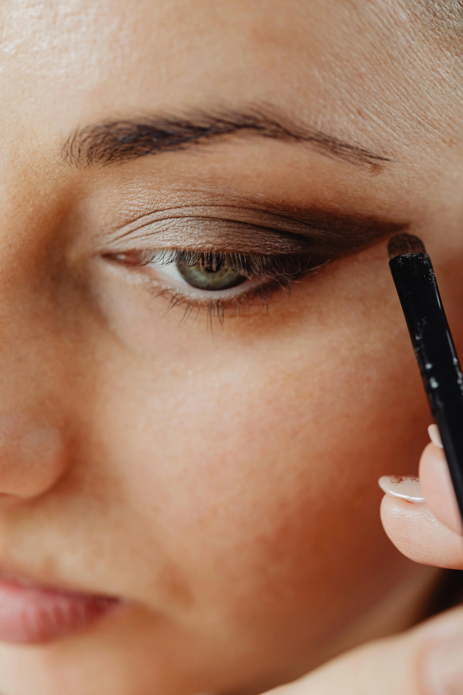 a close up of a person holding a pen