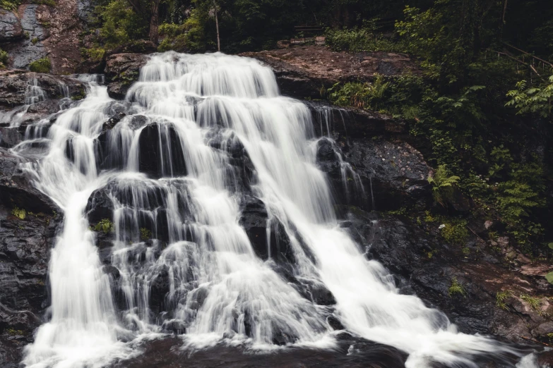 a big waterfall in the middle of a forest