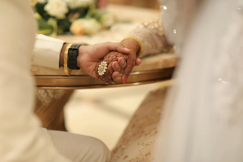 a close up of hands shaking each other at the end of a wedding ceremony