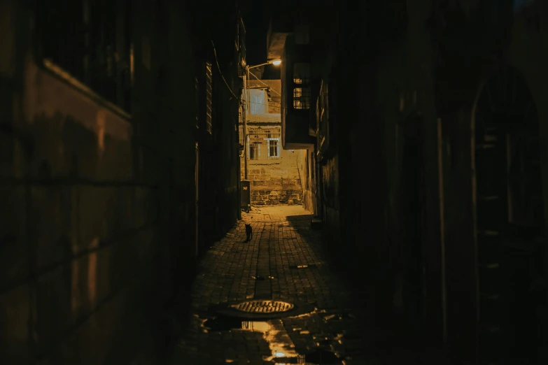 an alleyway with some doors and lights at night