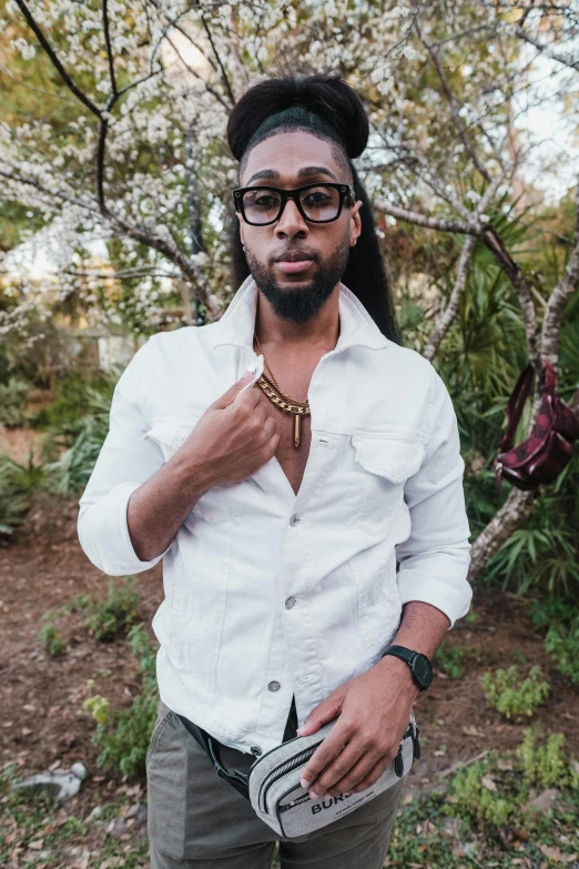 the man in glasses and shirt poses for the camera