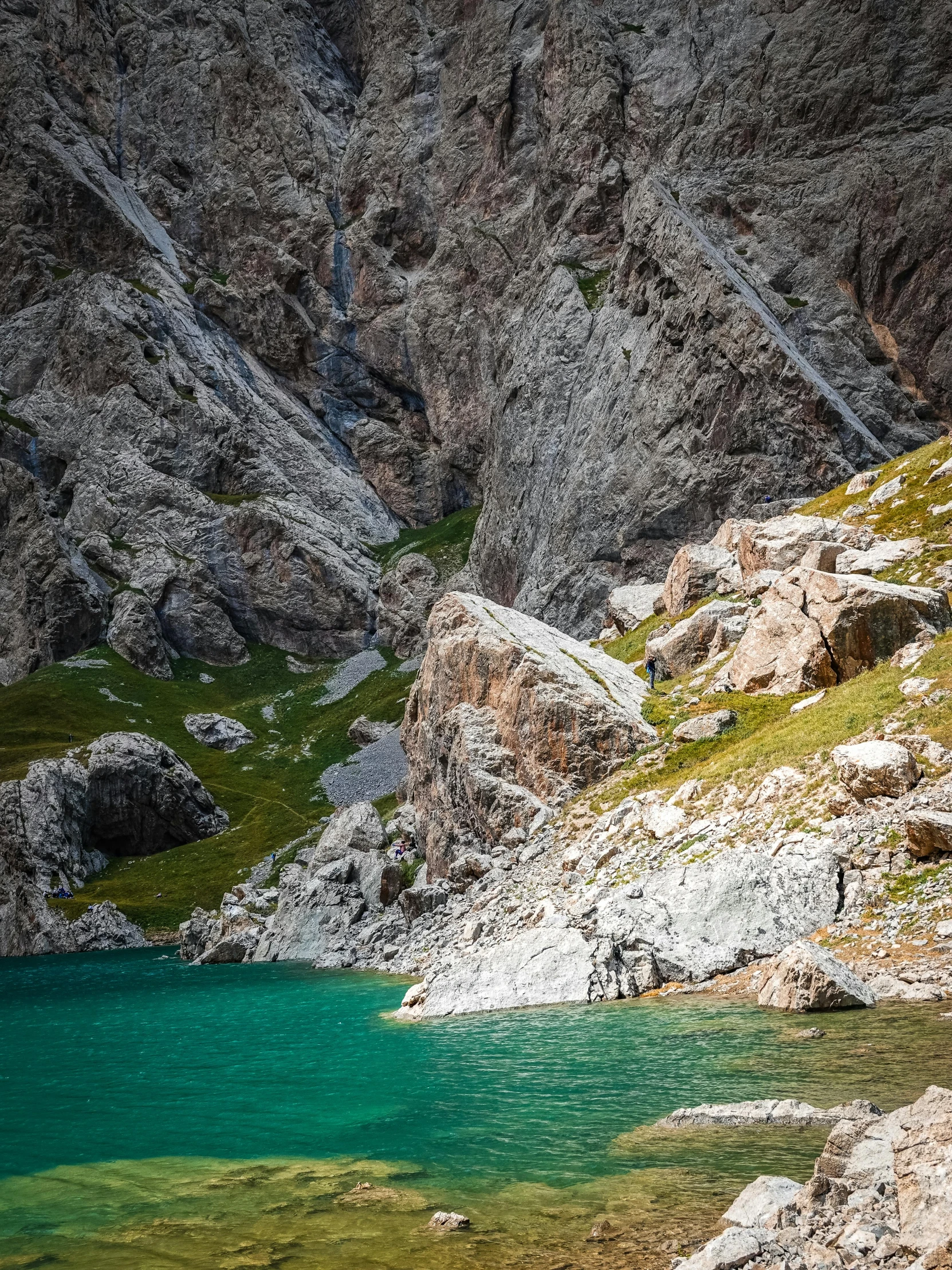 a large pond surrounded by some rocky mountains