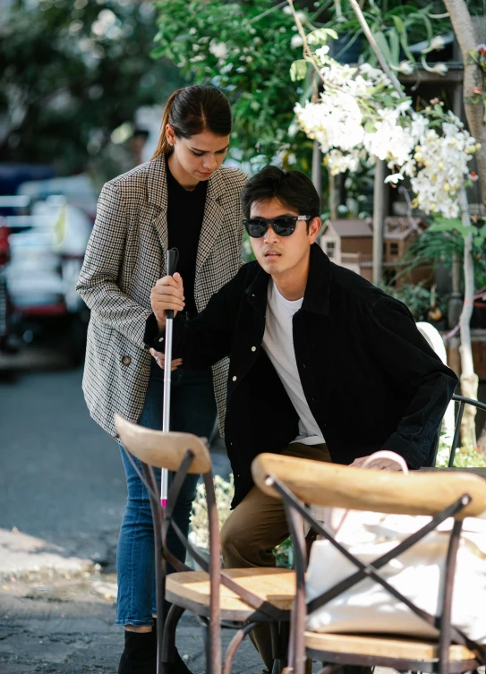 a couple dressed up with sunglasses on holding a cane