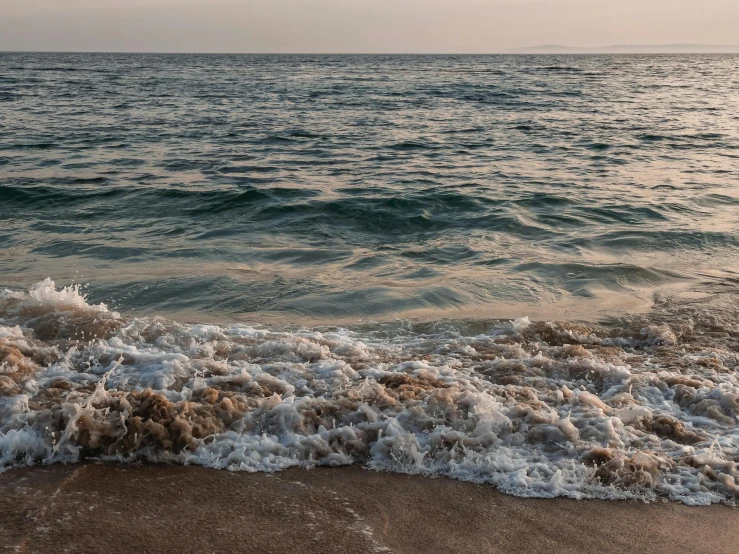 ocean waves in the surf on an overcast day